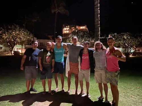 Team group photo outdoors at night during a company retreat